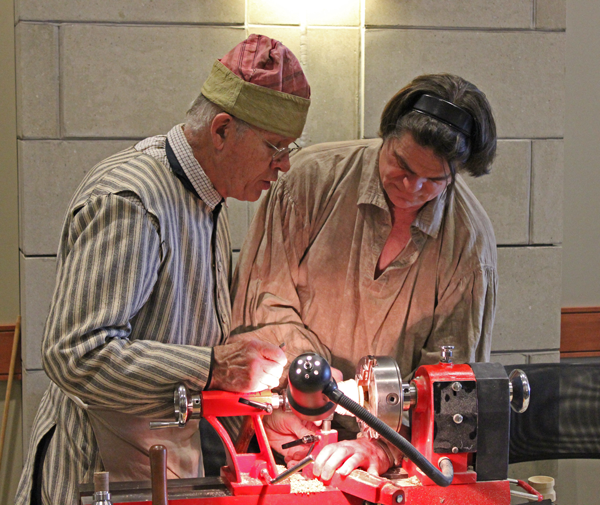 Erv Tschanz, Master Horner (left) instucts Fred Noesner on lathe work.